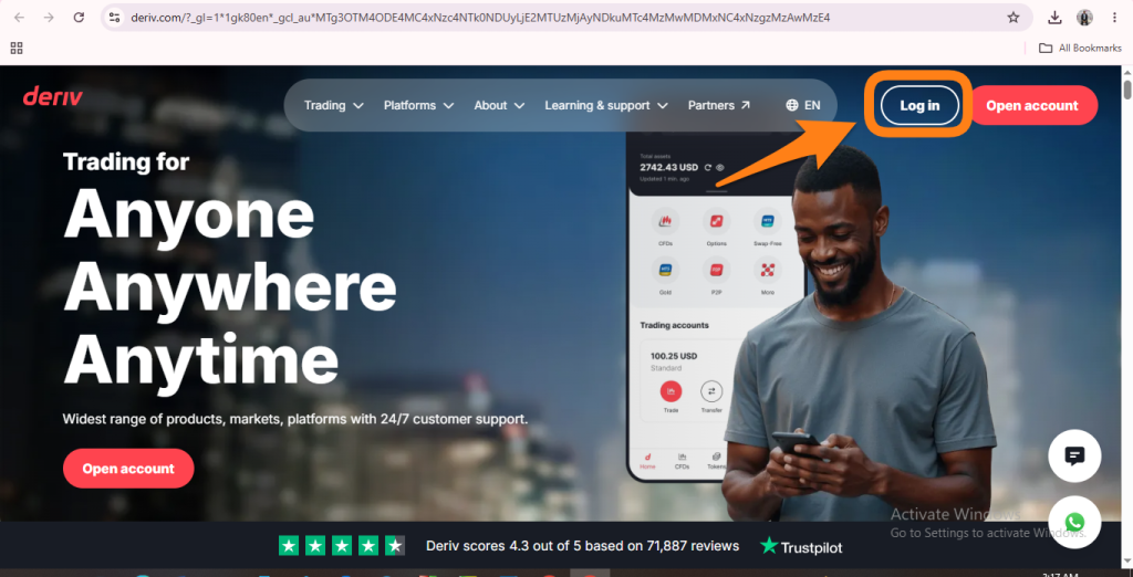 A man smiles while using his phone in front of a trading website. An orange arrow points to the “Log in” button at the top right corner of the webpage, highlighting where users can access their accounts or quickly resolve deriv login issues such as Deriv password reset and deriv forgot password queries. A man smiles while using his phone in front of a trading website. An orange arrow points to the “Log in” button at the top right corner of the webpage, highlighting where users can access their accounts or quickly resolve deriv login issues such as Deriv password reset and deriv forgot password queries.