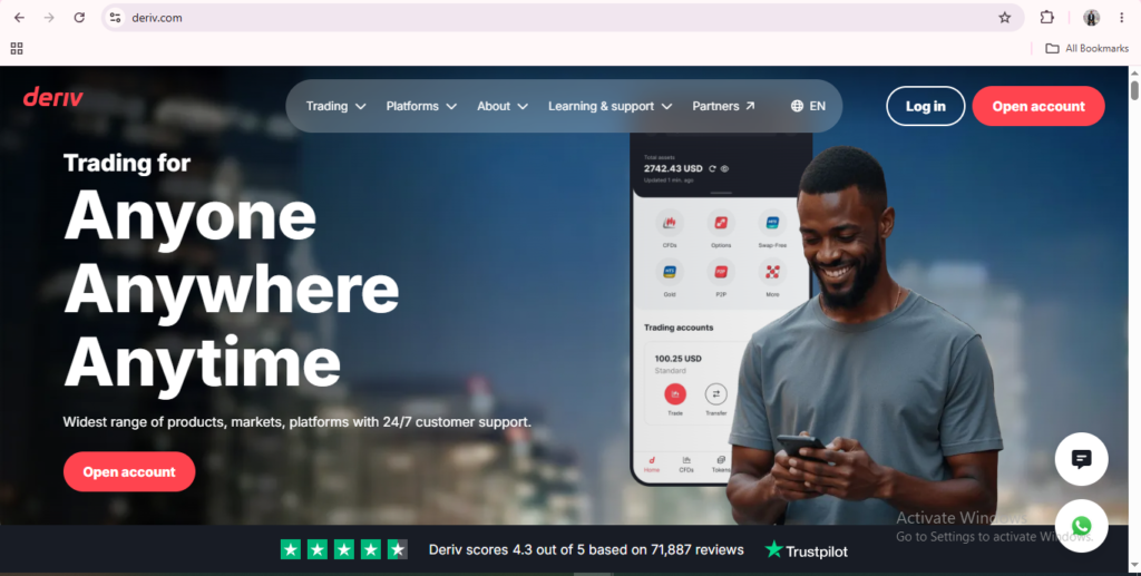 A man smiles while using his phone. The Deriv website promotes online trading with the slogan “Trading for Anyone, Anywhere, Anytime” and options to log in or open an account are clearly highlighted, demonstrating the user-friendly Deriv website layout.